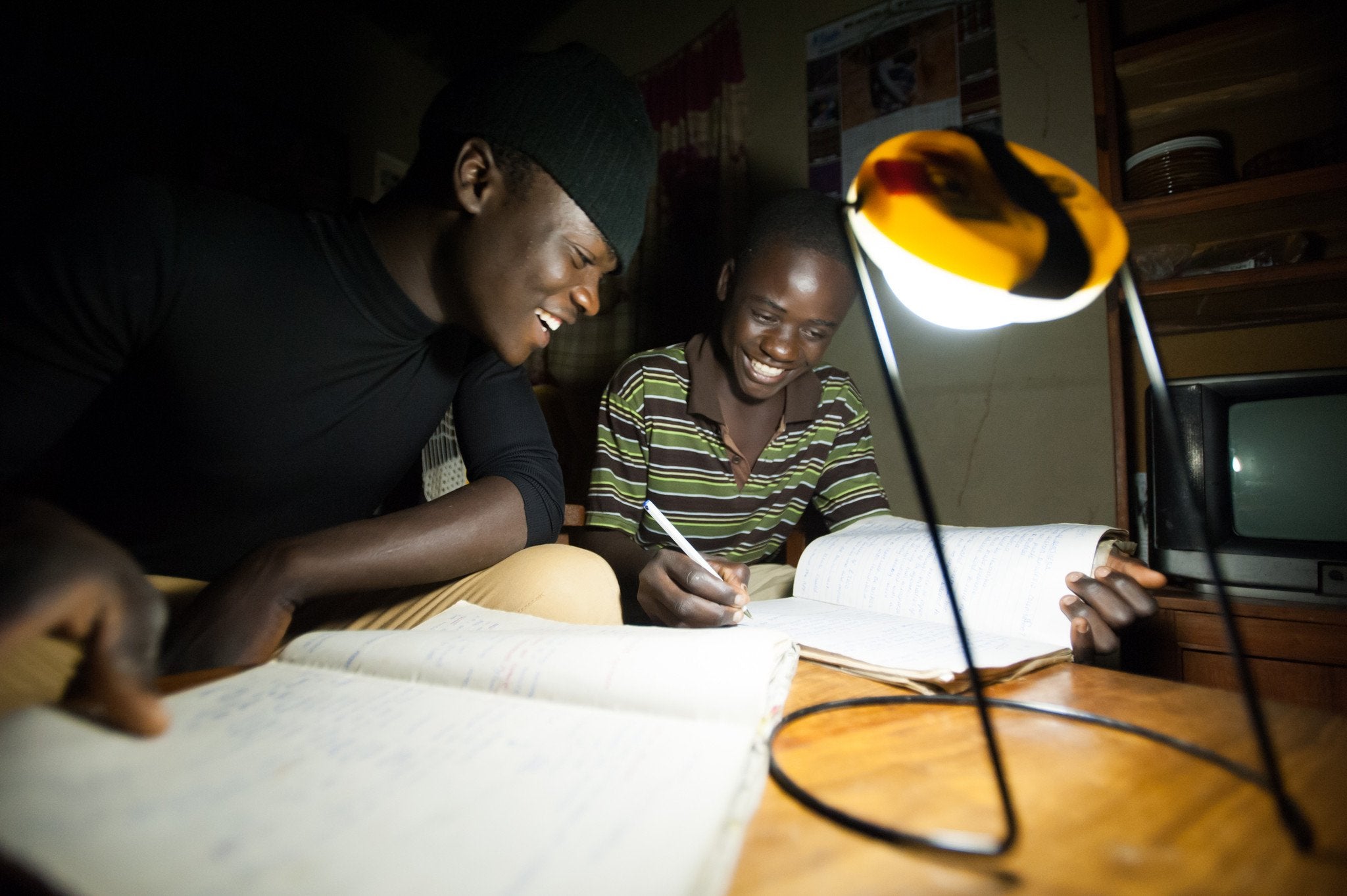 Two students study under the light of a Sun King Pro